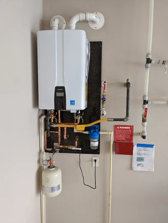Professional plumber installing copper piping in a Farley home